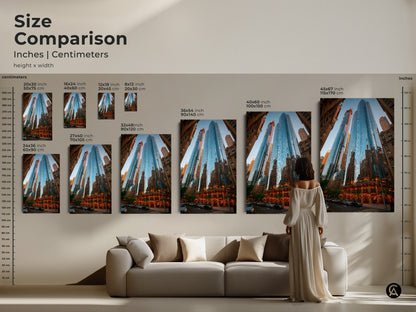 Size comparison for blue cityscape art prints in inches and centimeters. A woman is next to the art for scale. Sizes range from 20x30 cm to 115x170 cm. This artwork is perfect for a modern blue wall art setting.
