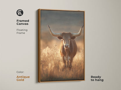 Framed canvas art of a longhorn bull in a savanna. This rustic western wildlife art features earthy tones and an antique gold floating frame. The golden yellow accent art print is ready to hang. It will add character to any room. This is perfect as rustic wall art.
