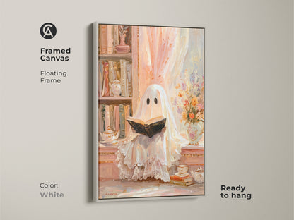 Framed canvas of a ghost reading wall art with a white floating frame. This pastel ghost artwork is ready to hang. It creates a cozy study room decor with an eclectic vibe. A unique Halloween gift for her. The bookshelf art print in cream peach offers a soft vintage touch for book lovers.