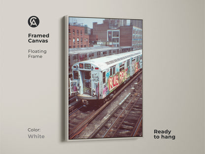 White framed canvas featuring a graffiti subway train. This urban street artwork is ready to hang. An industrial loft style wall decor with a cityscape view. Perfect as a hip hop fan gift.