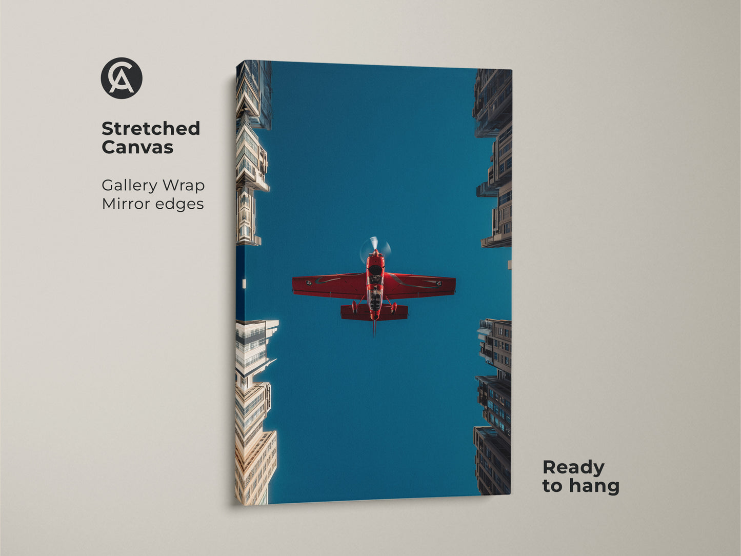 Stretched canvas aviation photography print showing a red airplane against a deep blue sky. The gallery wrap has mirror edges. Modern skyscraper wall art is ready to hang. This aviation enthusiast gift adds a dynamic feel to any space.