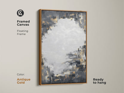 Framed canvas art displays charcoal grey and gold abstract design with an antique gold floating frame. This ready-to-hang piece adds a sophisticated touch. The contemporary artwork enhances a living room or office. Its neutral palette with metallic accents complements various decor styles.
