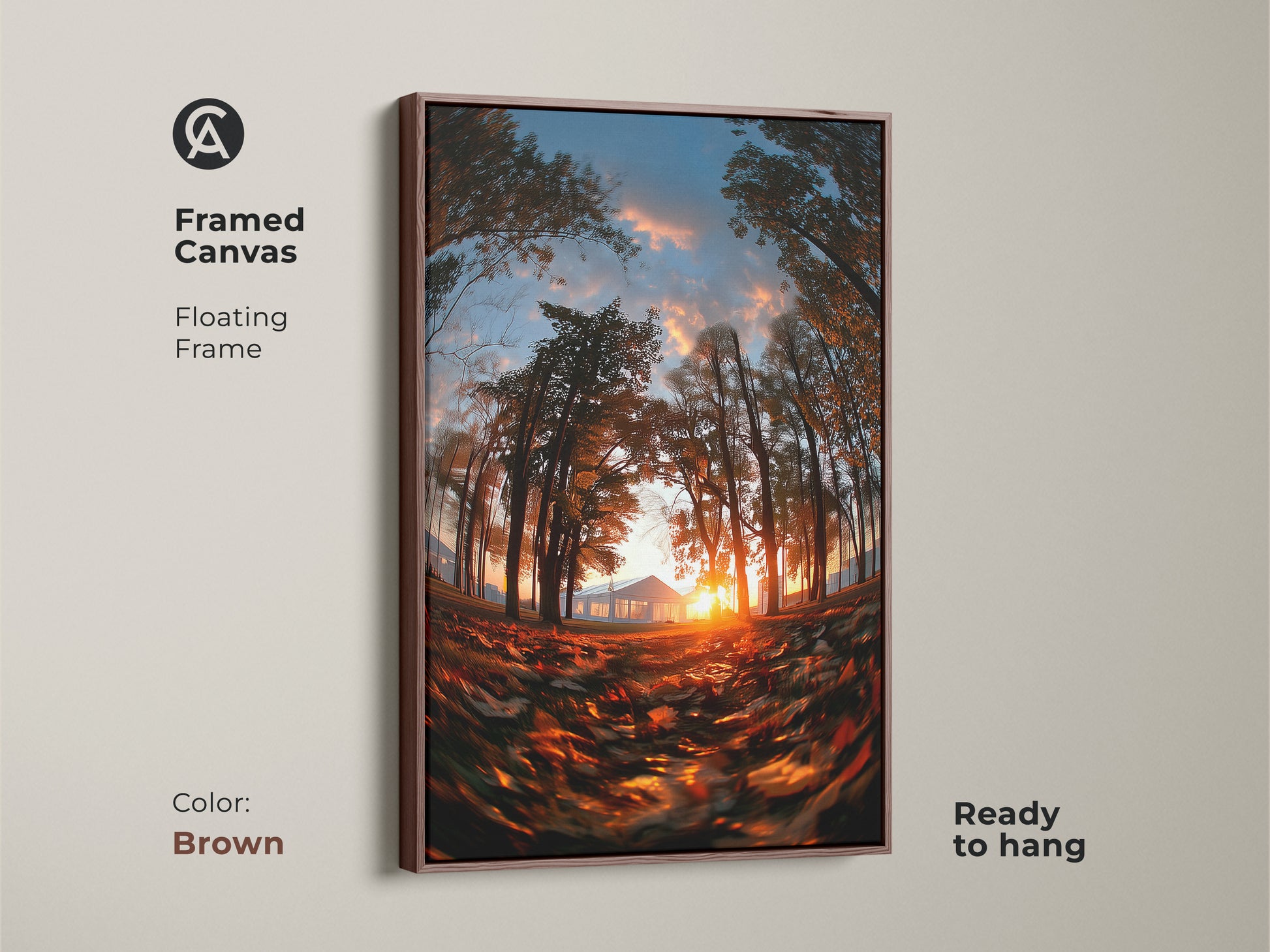 Framed canvas of a sunset through trees with a brown floating frame. The warm brown frame complements the artwork. The sun shines behind a distant house. Fallen leaves cover the ground. This nature art is ready to hang.