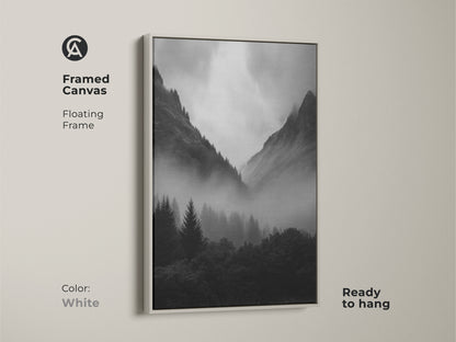 White framed canvas featuring monochrome forest artwork. Black and white mountain landscape provides modern nature decor. Misty pine trees create an atmospheric mountain view. This contemporary forest art is ready to hang.