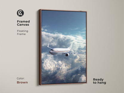 Framed canvas of an airplane flying through clouds. This aviation artwork has a brown floating frame and is ready to hang. It is a modern sky blue airplane print. Perfect for office decor or a travel gift.