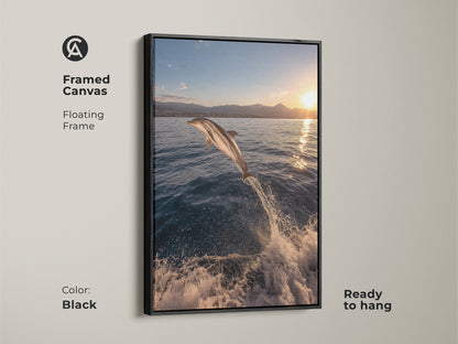 A framed canvas print of a dolphin jumping out of the ocean at sunset. The floating black frame enhances the deep blue ocean and golden yellow sky. This ready-to-hang coastal artwork brings a realistic ocean theme to any space. Perfect for beach house decor and art collectors.