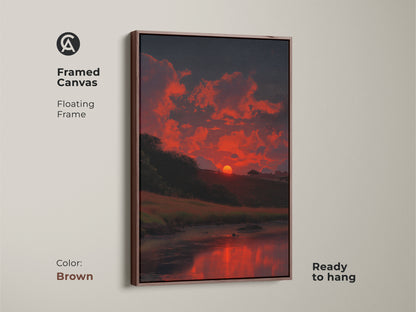 A framed canvas with a brown floating frame shows a dramatic sunset. The impressionistic artwork features fiery orange clouds and a dark blue sky. Ready to hang this nature print is ideal for home decor. The reflection of the sunset on the water adds depth and tranquility. This scenic artwork makes a thoughtful housewarming gift.
