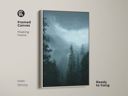Framed canvas with a white floating frame enhancing the moody forest landscape. Dark green pine trees and misty blue mountains create a tranquil scene. This nature home decor gift is ready to hang. Perfect as residential forest artwork.