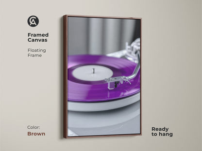 Framed canvas with a brown floating frame. The artwork showcases a purple vinyl record. This turntable canvas print is ready to hang. A distinctive piece of vintage audio art. It's a wonderful gift for any record collector.