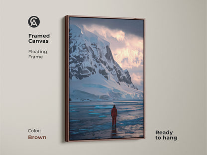 Framed canvas art of an Antarctic landscape with a brown floating frame. The artwork shows an explorer in a red suit surrounded by snowy mountains and ice. Perfect travel inspired wall art.
