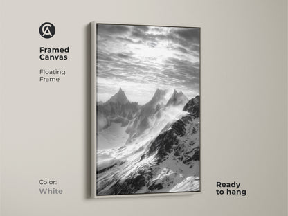 Framed canvas showcasing monochrome mountain art. The snowy peaks canvas print comes in a floating white frame. This black and white landscape adds elegance to any room. Nature wall decor perfect for modern homes.