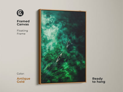 Antique gold framed canvas artwork featuring canoes on green waters. This floating frame art is ready to hang adding a vintage touch. The antique gold frame enhances the artwork's elegance and charm. Elevate your decor with this timeless and serene scene.