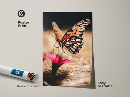 Poster print of an orange butterfly with pink floral elements. This nature photography art is easy to frame. The realistic butterfly print brings a boho touch to any room. Rolled in a tube for safe shipping. Vibrant insect artwork for nature lovers.
