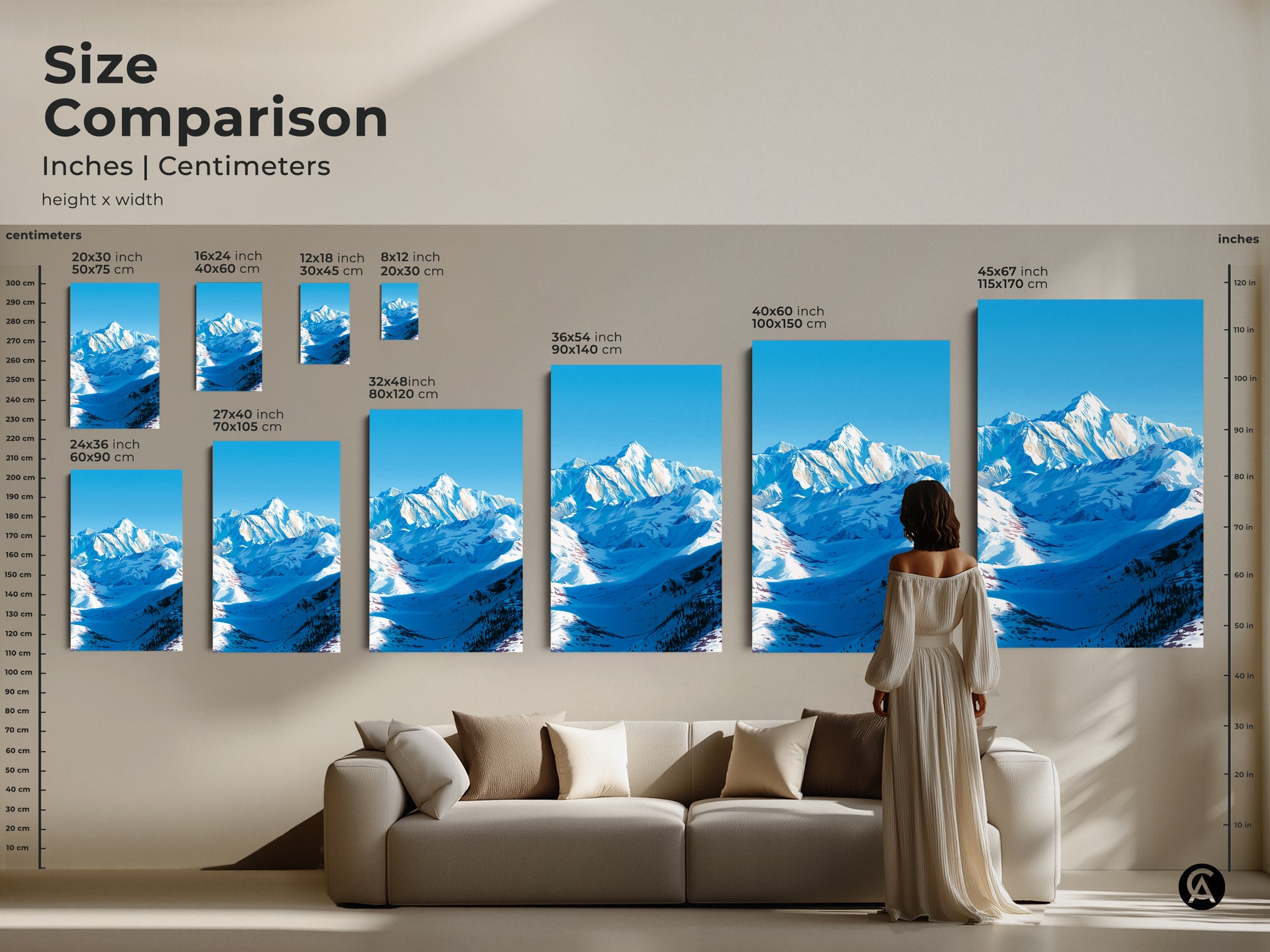 A size comparison displays various sizes of the snowy mountain canvas print above a sofa. Sizes range in inches and centimeters. This modern nature artwork is perfect for adding a touch of alpine scenery to any room. The blue and white art is ideal for bedroom wall decor or home office art.