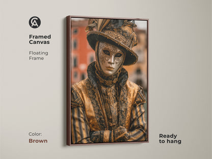 Brown framed canvas Venice Carnival Mask artwork. The artwork features a person wearing a traditional gold mask and costume. It adds an elegant touch to any room. This framed canvas is ready to hang.