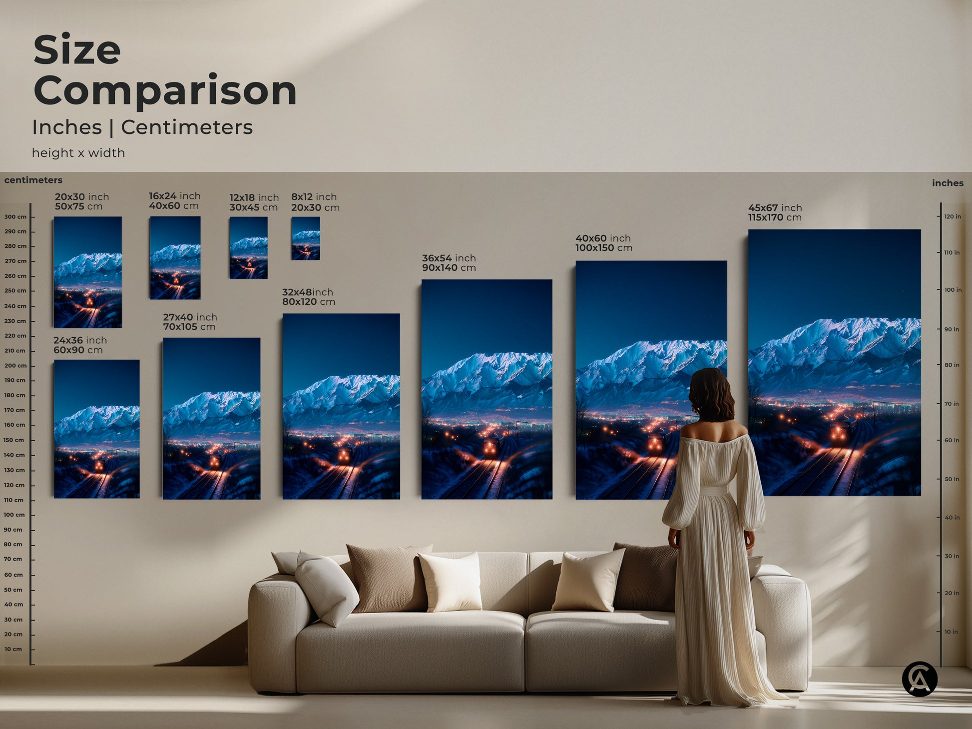 Size comparison of canvas prints. A woman stands near a sofa. The indigo mountains and train art range from 20x30 cm to 45x67 inches. The art becomes a focal point in any room. The blue orange landscape is a modern home gift.