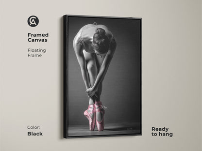 Black framed canvas of a ballerina. The art shows a dancer in pink pointe shoes. A floating frame adds a modern touch. Ready to hang and enhance your home decor with this piece.