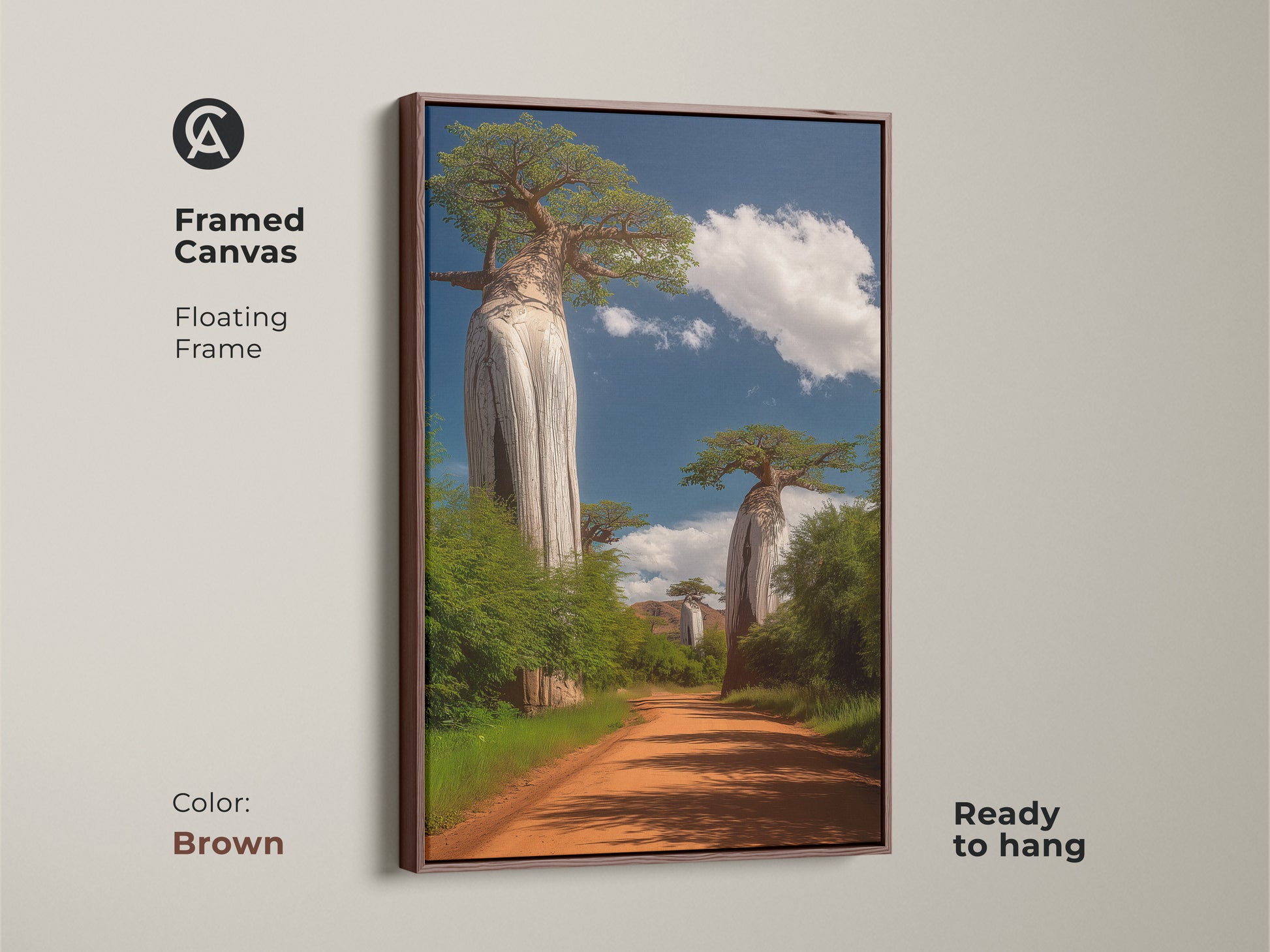 Framed Canvas of African Baobab Tree art in brown floating frame. This boho wall decor shows a dirt road and green trees. This African landscape print is a travel themed gift. Realistic nature artwork is ready to hang.
