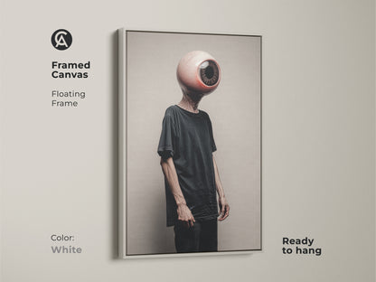 This white framed canvas showcases a surreal eyeball head. The conceptual figure art enriches any modern wall. Ready to hang this dark aesthetic wall decor brings eclectic flair. This unique gift is ideal for an art lover or Halloween adding a sophisticated touch.