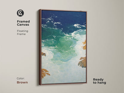 Framed Canvas in Brown color shows abstract ocean waves artwork ready to hang. This coastal modern wall art piece features a deep blue emerald seascape for a refined look. A residential abstract painting on canvas is perfect as a beach lover housewarming gift. Enhance your space with emerald green ocean print a coastal abstract artwork.