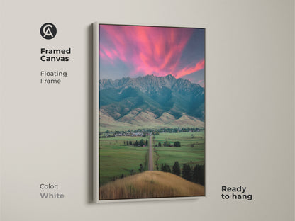 White framed canvas showcases a pink sunset mountain landscape. The ready-to-hang floating frame art enhances any space. Complements modern farmhouse decor. A housewarming gift for outdoor lovers. Scenic bedroom wall art adds charm to residential decor.