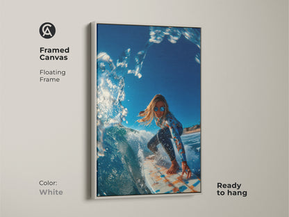 White framed canvas artwork of a surfer girl riding a wave. The frame is a floating frame. This framed art is ready to hang. The surfer is wearing sunglasses and a long-sleeve swimsuit.