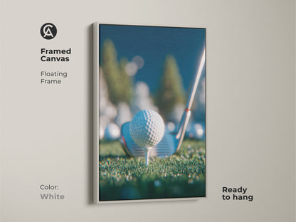 Framed canvas artwork in a white floating frame shows a golf ball on a tee. It comes ready to hang. This print is perfect for golf enthusiasts. Bring a clean sporty touch to your space. Shop framed golf art now.