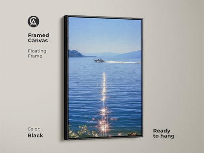 Black framed canvas featuring a boat on blue water. This sparkling ocean artwork shows a realistic lake landscape. It is ready to hang and will enhance coastal bedroom wall decor for boat lovers. Enjoy summer water scene art as nautical home decor. Modern boat artwork for calm spaces.
