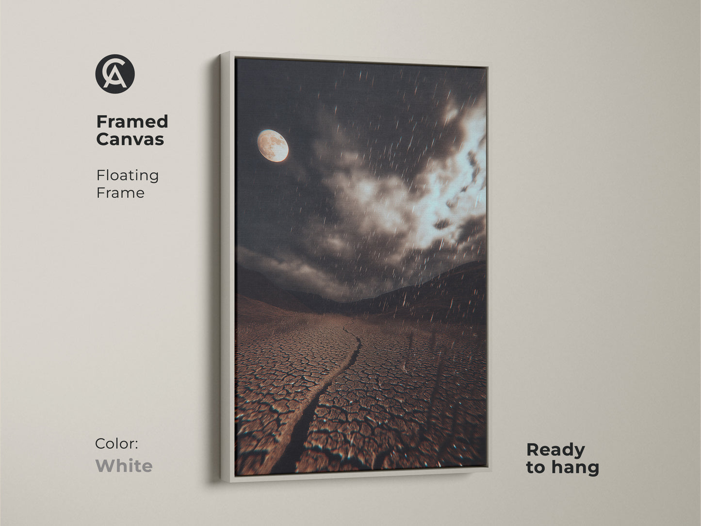 White framed canvas art. It shows a surreal moonlit desert landscape. This dark brown cracked earth art has a grey rainy night sky. It's ready to hang.