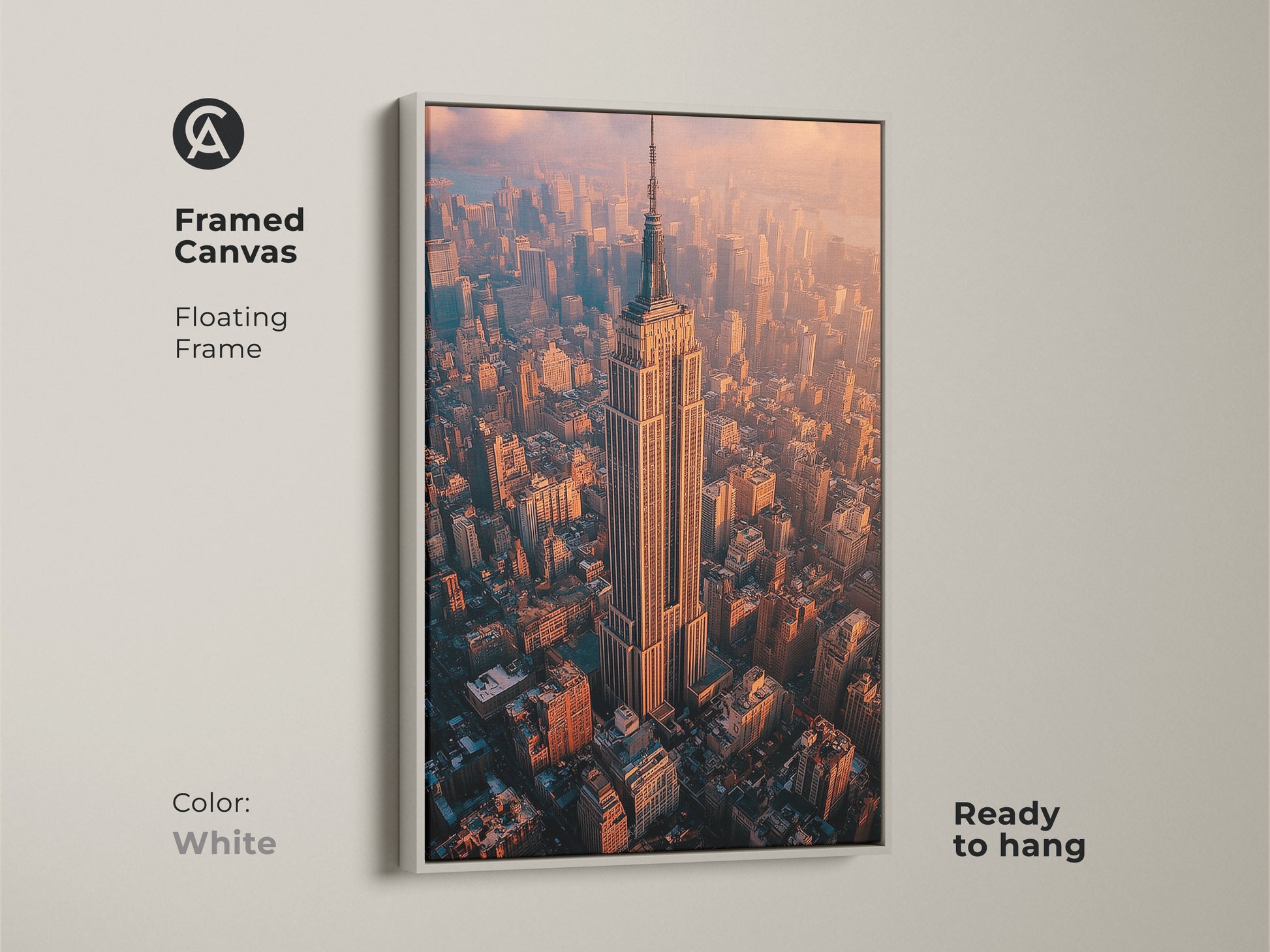 White framed canvas art featuring the Empire State Building. A floating frame adds a clean sophisticated touch. Ready to hang artwork captures the iconic skyscraper in the heart of New York City from above.