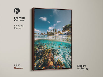 Brown framed canvas print of a tropical ocean split view. It showcases a beach with palm trees and an underwater coral reef. Coastal living room art ready to hang.