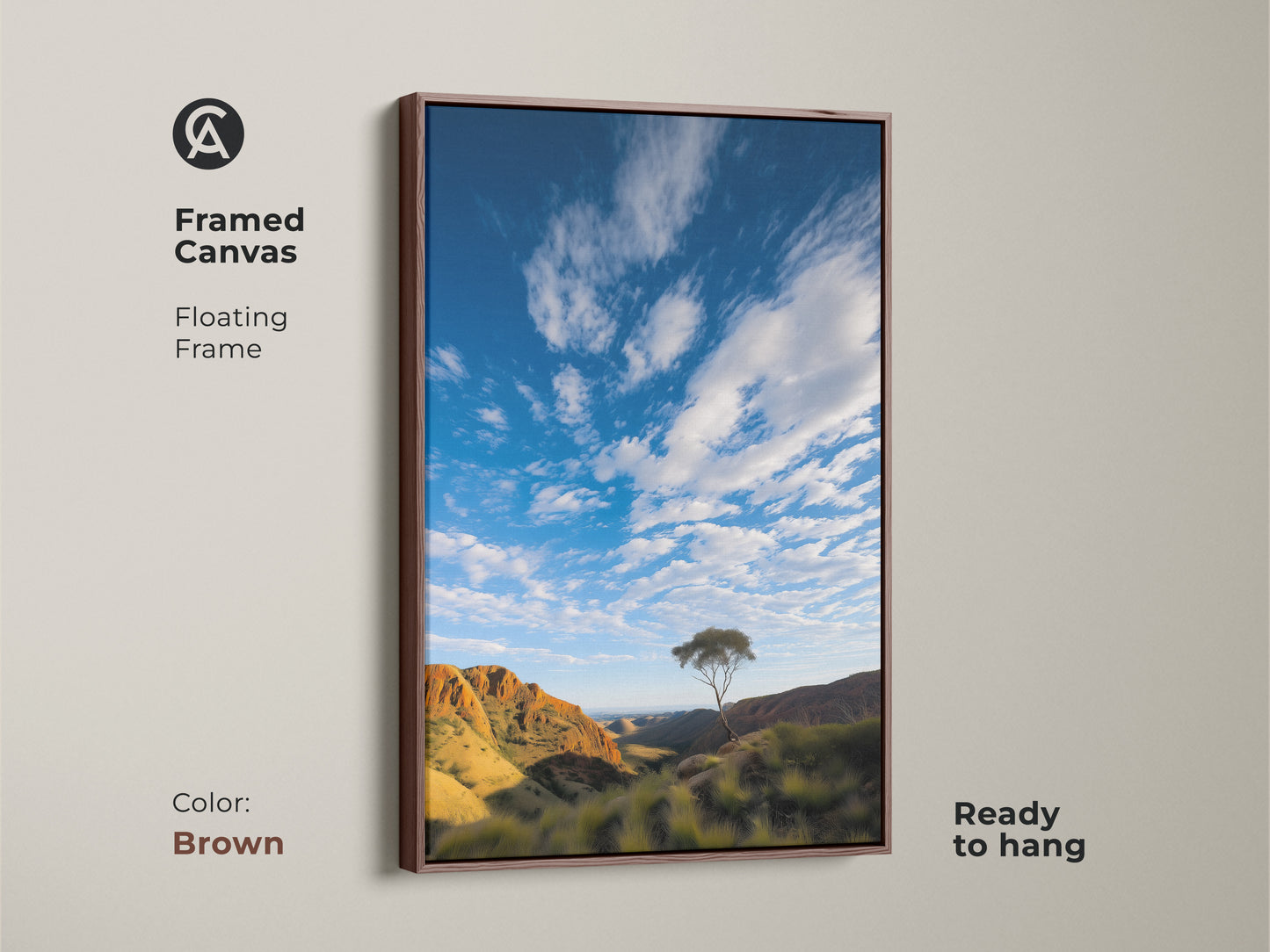 Framed canvas showcasing a scenic Australian Outback landscape. The photorealistic mountain art print features a lone tree and a blue sky. The brown floating frame enhances the earthy tones. This nature artwork is ready to hang and brings the beauty of the desert landscape indoors.