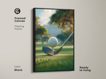 A black framed canvas golf art print ready to hang. The artwork shows a golf ball on a tee ready to be hit. The background is a green golf course with trees and a hill. This framed golf art print is perfect for your home or office.