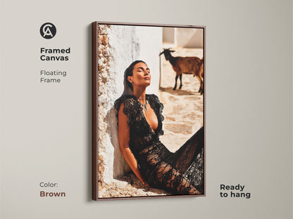 Framed Canvas with a floating brown frame. The artwork shows fashion photography. Woman in black lace dress with a goat is featured. This artwork is ready to hang and brings an eclectic touch. Adds a distinctive style for housewarming. Perfect wall decor for contemporary interiors.