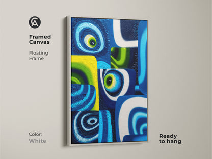 Framed canvas of a modern abstract painting with blue and green swirls. This geometric artwork is a vibrant piece of contemporary wall decor perfect for adding color to a modern office. The white floating frame accentuates the piece making it ready to hang.
