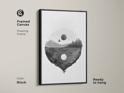 Framed canvas featuring surreal floating island art with a black floating frame. The minimalist moon landscape is ready to hang. The black and white abstract wall art brings a touch of fantasy and contemplation to a bedroom or living room.