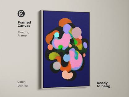 Framed canvas with a floating frame in white showcasing abstract art. The modern artwork features geometric shapes in colors like indigo pink and green. Ready to hang this contemporary print adds a touch of sophistication to any room's wall decor.