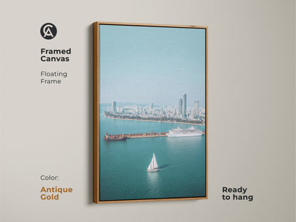 Framed Canvas with a floating antique gold frame. This Ocean View art print features a sailboat cruise ship. Blue teal artwork adds a contemporary touch to any residential space.
