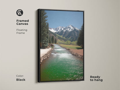 Framed canvas of a turquoise river landscape art. Floating in a sleek black frame this rustic mountain scene is ready to hang. The pine trees and snow capped mountains add a touch of nature. Great wall art for any home.