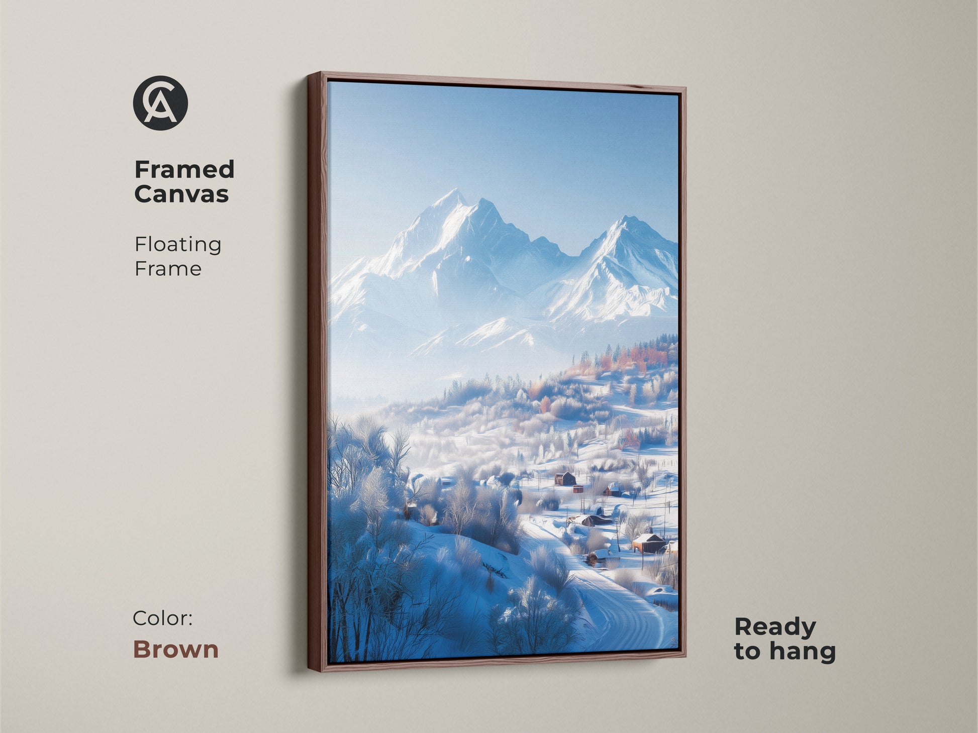 This framed canvas print features a winter mountain scene. A brown floating frame enhances the artwork. The print shows snow-covered houses nestled in a valley. Distant mountains add to this ready-to-hang piece.