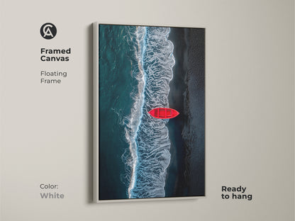 Framed canvas artwork featuring a red boat on a beach. White floating frame. Ready to hang. Ocean wave art brings a calming coastal vibe. This piece enhances any room.