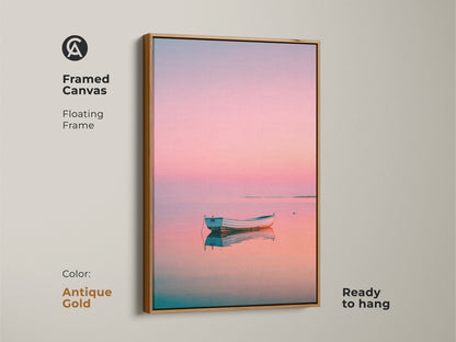 Framed canvas art with a boat at sunset. The floating frame is antique gold. It is ready to hang. The pastel shades create a calming effect. Explore framed artwork to enhance your home decor.