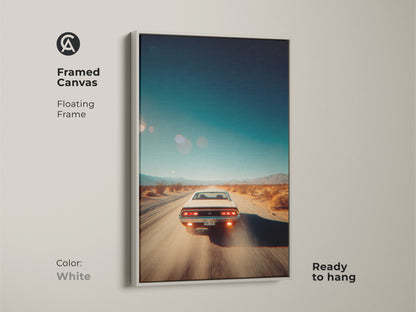 White framed canvas artwork depicting a vintage car speeding through a desert landscape. The floating frame offers a clean elegant look. This ready-to-hang artwork is perfect for car lovers. Complement your home decor with this white framed art piece.