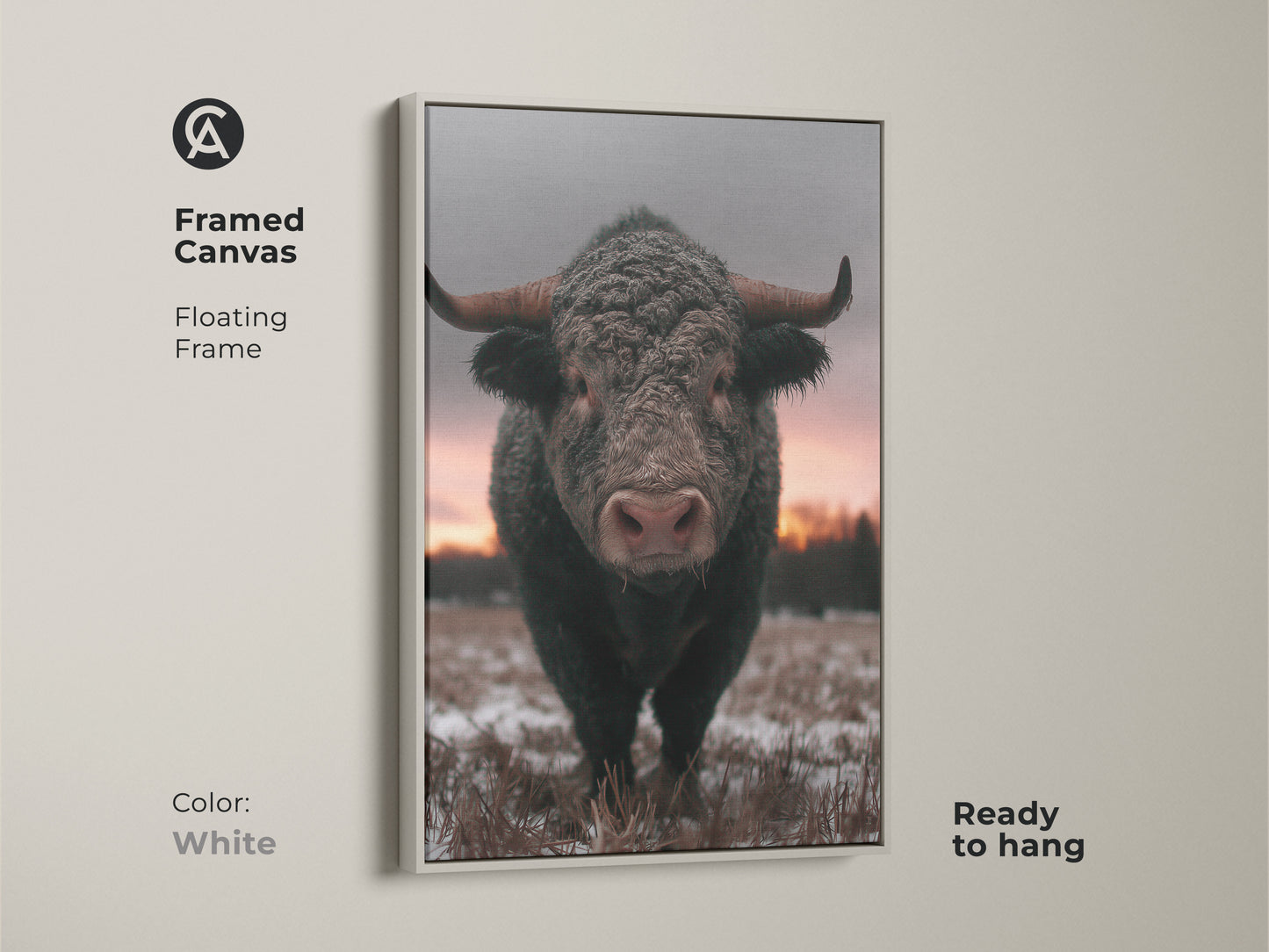 Framed canvas print of a bull in a winter scene. White floating frame enhances this rustic farmhouse wall art. Wildlife animal print ready to hang. A cozy addition to your bedroom decor. Brown gray pink art perfect for country chic style.