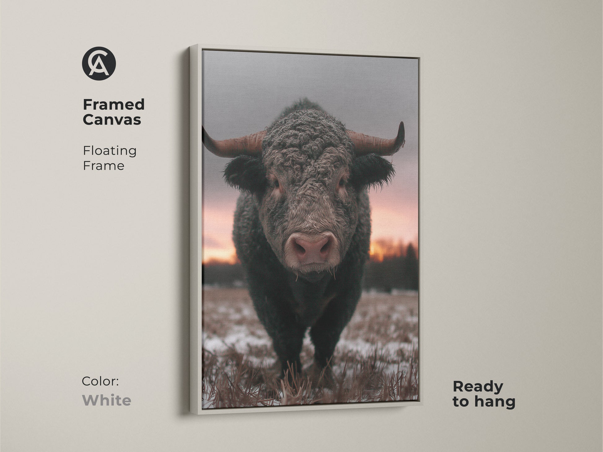 Framed canvas print of a bull in a winter scene. White floating frame enhances this rustic farmhouse wall art. Wildlife animal print ready to hang. A cozy addition to your bedroom decor. Brown gray pink art perfect for country chic style.