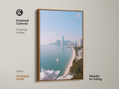 A framed canvas showing coastal cityscape art with a yacht and sailboat. This floating frame artwork is ready to hang and features an antique gold frame. The ocean view art print features modern aqua blue artwork. It is a contemporary cityscape print perfect for travel lovers. The coastal scene offers nautical themed wall decor.