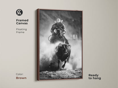 Brown framed canvas with floating frame featuring black and white rodeo art. This bull riding canvas print showcases western cowboy wall art. A rustic ranch art print is ready to hang. Ideal action sports photography for man cave rodeo decor.