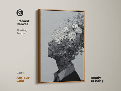 Framed canvas artwork with a floating frame. The art shows a black and white drawing of a floral head. This canvas comes in an antique gold frame. It is ready to hang and will add a touch of elegance to your wall decor.
