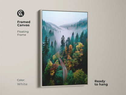 White framed canvas art of forest. The floating frame highlights the forest artwork. The misty forest scene is printed on high-quality canvas. The art is ready to hang. This framed artwork creates a clean and modern look. The artwork is a stunning addition to your wall decor.