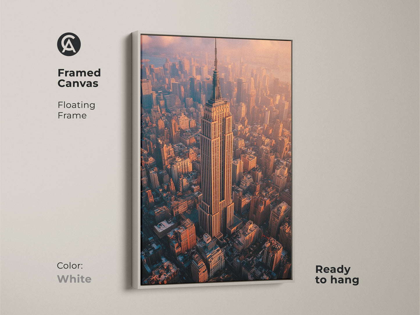 Framed canvas floating frame in white featuring the Empire State Building. Ready to hang aerial NYC photography print. This contemporary artwork showcases a golden hour cityscape. It brings the grandeur of New York City to your space. Perfect for urban photography enthusiasts and as office wall art. This modern piece is ideal for home office decor.